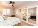 Bright bedroom featuring a window with shutters, closet with mirrored doors, and ceiling fan at 3522 E Cherokee St, Phoenix, AZ 85044