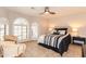 Bedroom featuring unique windows with shutter detail, light carpet, and a ceiling fan at 3522 E Cherokee St, Phoenix, AZ 85044