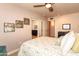 Cozy bedroom featuring patterned bedding, stylish artwork, and a ceiling fan at 3522 E Cherokee St, Phoenix, AZ 85044