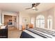 A bedroom featuring a ceiling fan, unique windows, and comfortable chairs at 3522 E Cherokee St, Phoenix, AZ 85044