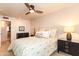 Comfortable bedroom with patterned bedding, dark wood furniture and a ceiling fan at 3522 E Cherokee St, Phoenix, AZ 85044