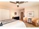 Bright bedroom featuring neutral walls, ceiling fan, decorative chairs, and closet at 3522 E Cherokee St, Phoenix, AZ 85044