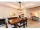 Dining area with sleek furnishings, statement lighting, and an adjacent living room at 3522 E Cherokee St, Phoenix, AZ 85044