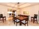 Dining room with dark wood table, modern lighting, and views into the kitchen at 3522 E Cherokee St, Phoenix, AZ 85044