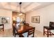 Dining room featuring stylish lighting, dark wood furniture, and connections to the living area at 3522 E Cherokee St, Phoenix, AZ 85044
