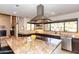 Modern kitchen with island, stainless steel appliances, granite countertops, and a view to the living area at 3522 E Cherokee St, Phoenix, AZ 85044
