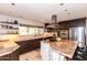 Kitchen with stainless steel appliances, granite counters, large island with seating, and ample natural light at 3522 E Cherokee St, Phoenix, AZ 85044