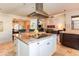 Bright kitchen with granite countertops, island, and stainless steel appliances, seamlessly connected to living spaces at 3522 E Cherokee St, Phoenix, AZ 85044