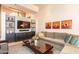 Comfortable living room with stylish decor, including a large sofa and decorative artwork on the walls at 3522 E Cherokee St, Phoenix, AZ 85044