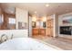 A spacious main bathroom featuring dual sinks, a soaking tub, a glass block shower, and a fireplace at 3522 E Cherokee St, Phoenix, AZ 85044