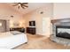 A large main bedroom features a vaulted ceiling, fireplace, tv, seating area, and ensuite living area at 3522 E Cherokee St, Phoenix, AZ 85044