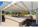 Covered outdoor bar area featuring a grill, sink, and plenty of counter space for entertaining at 3522 E Cherokee St, Phoenix, AZ 85044