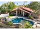 Resort style backyard with private pool, hot tub, outdoor kitchen, and lush landscaping at 3522 E Cherokee St, Phoenix, AZ 85044