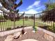 Backyard area featuring secure fencing, desert landscaping, stone accents, and green space at 3780 E Rakestraw Ln, Gilbert, AZ 85298
