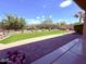 Landscaped backyard features green turf, decorative rock, and brick pavers with a partial view of the fence line at 3780 E Rakestraw Ln, Gilbert, AZ 85298