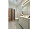 Bright bathroom featuring a shower with a colorful shower curtain, vanity, and ample lighting at 3780 E Rakestraw Ln, Gilbert, AZ 85298