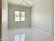 Bright bedroom with neutral tones and white tile flooring, featuring a window with a treeline view at 3780 E Rakestraw Ln, Gilbert, AZ 85298
