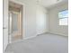 Bright bedroom with neutral carpet, a window offering natural light, and closet space, creating a cozy atmosphere at 3780 E Rakestraw Ln, Gilbert, AZ 85298