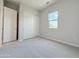 This bright bedroom features soft carpet, ample closet space, and a window with a view of the outdoors at 3780 E Rakestraw Ln, Gilbert, AZ 85298