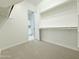 Walk-in closet leading to another room, featuring shelving and hanging rods at 3780 E Rakestraw Ln, Gilbert, AZ 85298
