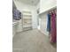 Bright walk-in closet featuring built-in shelving and ample hanging space for organization at 3780 E Rakestraw Ln, Gilbert, AZ 85298