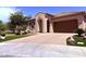 Attractive single-story home showcasing desert landscaping, an arched entryway, a paved driveway, and an attached garage at 3780 E Rakestraw Ln, Gilbert, AZ 85298