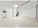 Clean, well-lit garage with epoxy flooring, storage cabinet, and garage door opener at 3780 E Rakestraw Ln, Gilbert, AZ 85298