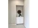 A decorative nook features a storage cabinet with a plant and art, adding character to the home at 3780 E Rakestraw Ln, Gilbert, AZ 85298