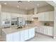 Spacious kitchen with white cabinets, quartz countertops, and stainless steel appliances at 3780 E Rakestraw Ln, Gilbert, AZ 85298