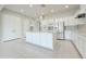 Spacious kitchen featuring white cabinets and island, with modern appliances and sleek tile flooring at 3780 E Rakestraw Ln, Gilbert, AZ 85298