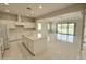 Open-concept kitchen featuring white cabinets, a central island, and tile flooring, ideal for modern living at 3780 E Rakestraw Ln, Gilbert, AZ 85298