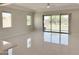 Bright living room with tile floors, offers natural light and backyard views through large sliding glass doors at 3780 E Rakestraw Ln, Gilbert, AZ 85298
