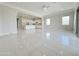 Expansive living room and kitchen boasts modern tile floors, bright windows, and an open layout at 3780 E Rakestraw Ln, Gilbert, AZ 85298