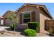 Attractive home exterior showcasing a manicured yard, desert landscaping, and inviting window shutters at 44837 W Horse Mesa Rd, Maricopa, AZ 85139