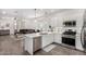 Open-concept kitchen featuring stainless steel appliances, a gas range, and an adjacent living space at 44837 W Horse Mesa Rd, Maricopa, AZ 85139