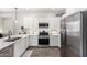 Well-appointed kitchen with stainless steel appliances, gas range, sleek countertops, and modern lighting at 44837 W Horse Mesa Rd, Maricopa, AZ 85139