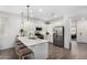 Bright kitchen with modern stainless steel appliances, quartz countertops, and large island with barstool seating at 44837 W Horse Mesa Rd, Maricopa, AZ 85139
