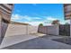 Enclosed backyard featuring block wall, stone border, and concrete pad at 5008 W New World Dr, Glendale, AZ 85302