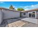Enclosed backyard with a sliding glass door, concrete pad and rock area at 5008 W New World Dr, Glendale, AZ 85302
