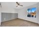 Minimalist bedroom featuring a paneled wall and natural light from the window at 5008 W New World Dr, Glendale, AZ 85302