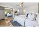 Bright bedroom with mirrored closet doors and a view to an ensuite bathroom at 5008 W New World Dr, Glendale, AZ 85302