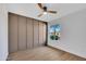 Empty bedroom with a paneled wall, ceiling fan, and natural light from the window at 5008 W New World Dr, Glendale, AZ 85302