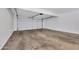 Empty garage with white door and interior with concrete floor at 5008 W New World Dr, Glendale, AZ 85302