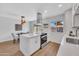 Open-concept kitchen featuring a center island, stainless steel hood, and adjacent dining area at 5008 W New World Dr, Glendale, AZ 85302