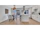 Bright, open kitchen featuring quartz countertops, white cabinetry, and modern stainless steel appliances at 5008 W New World Dr, Glendale, AZ 85302