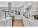 Modern kitchen with stainless steel appliances, white cabinetry, and a bright window at 5008 W New World Dr, Glendale, AZ 85302