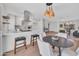 Stylish kitchen with quartz countertops, white cabinetry, and direct access to living area at 5008 W New World Dr, Glendale, AZ 85302