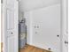 Bright utility room featuring water heater, hook ups, and access panel at 5008 W New World Dr, Glendale, AZ 85302