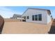 Spacious backyard awaiting landscaping with a view of the new construction home at 537 E Aurora Dr, San Tan Valley, AZ 85140
