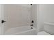 A pristine bathroom with a bathtub-shower combination offers a relaxing bathing experience at 537 E Aurora Dr, San Tan Valley, AZ 85140